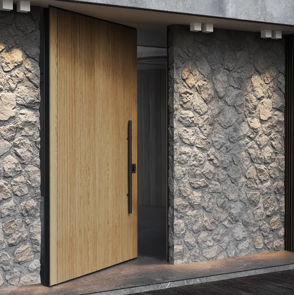 Puerta pivotante ICA PIVO con acabado de madera en una fachada de piedra
